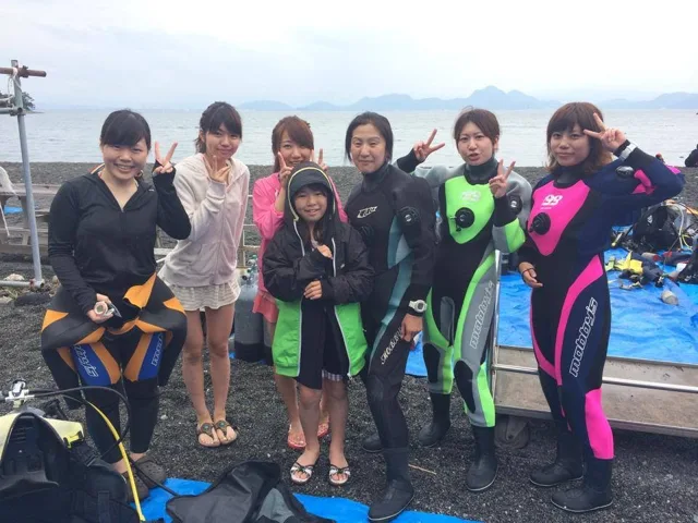 海辺で記念撮影するBIG BLUEの参加者(2014年)