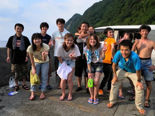 海辺で記念撮影するBIG BLUEの参加者(2012-2013年)