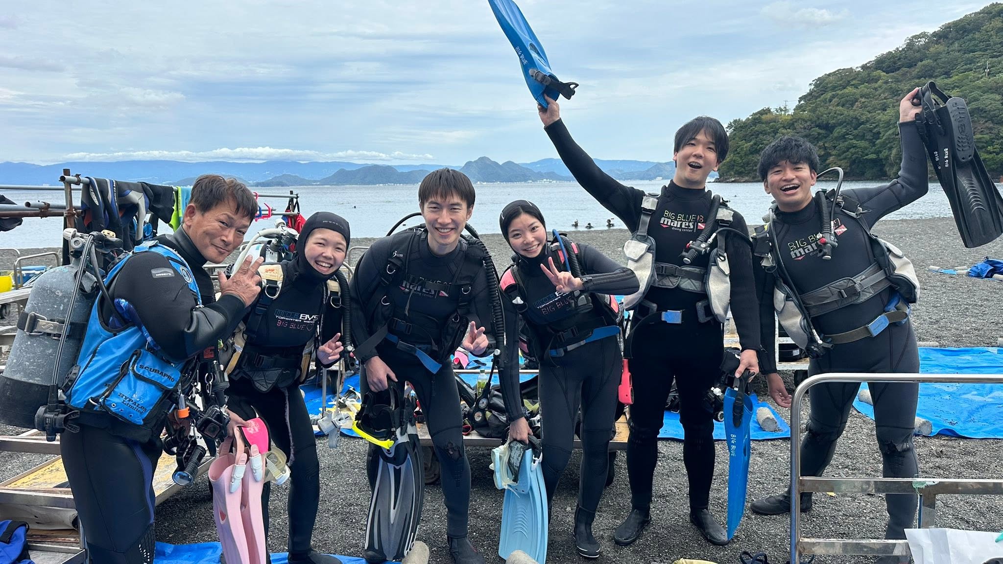 2025年11月3日(投稿日) / 海辺でウェットスーツ姿で並ぶダイビングの参加者